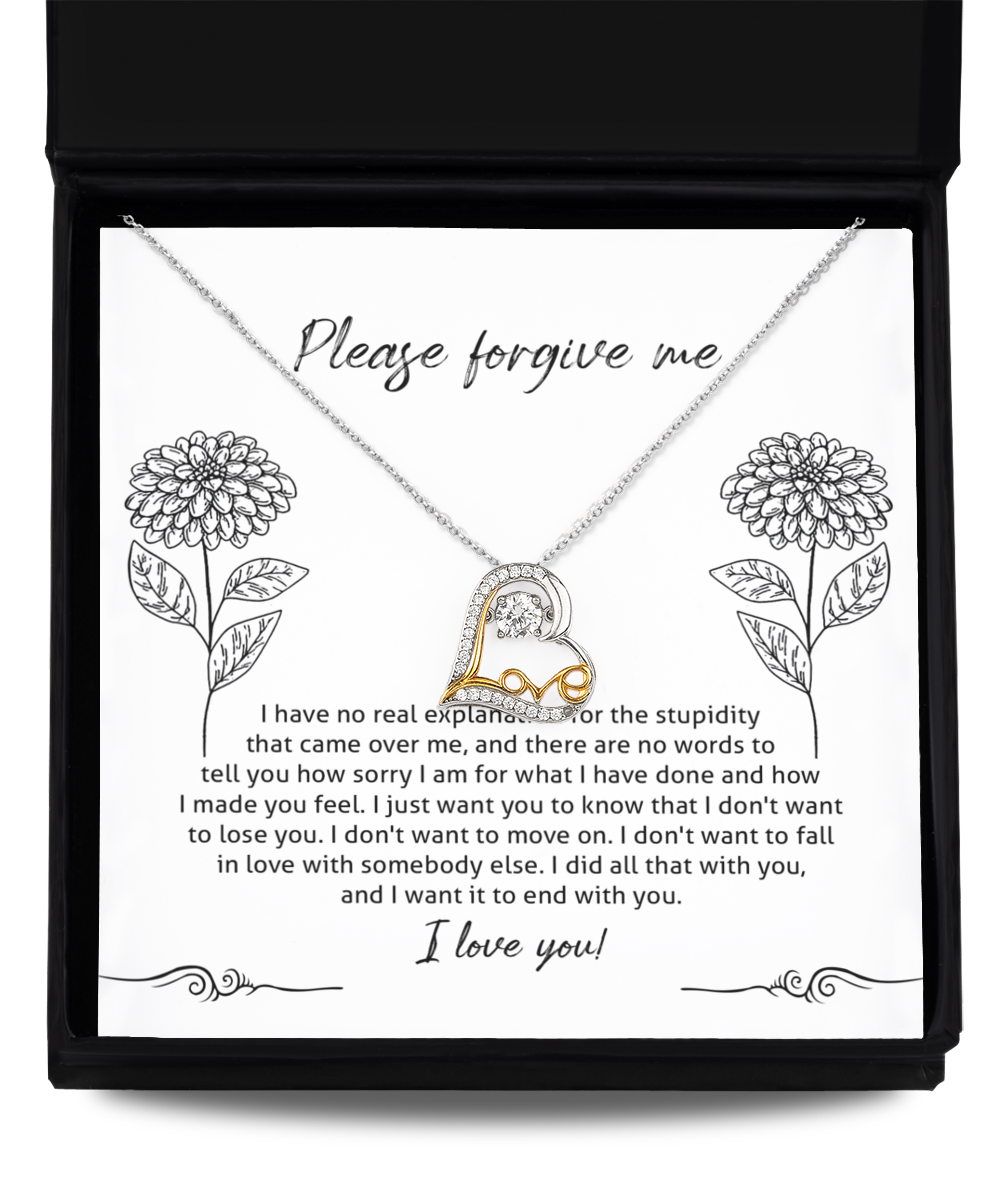 The Sorry-Real Explanation - Love Dancing Necklace, crafted from sterling silver with a heart-shaped pendant, is placed inside a box. The inner lid of the box features an apology message surrounded by flower illustrations.