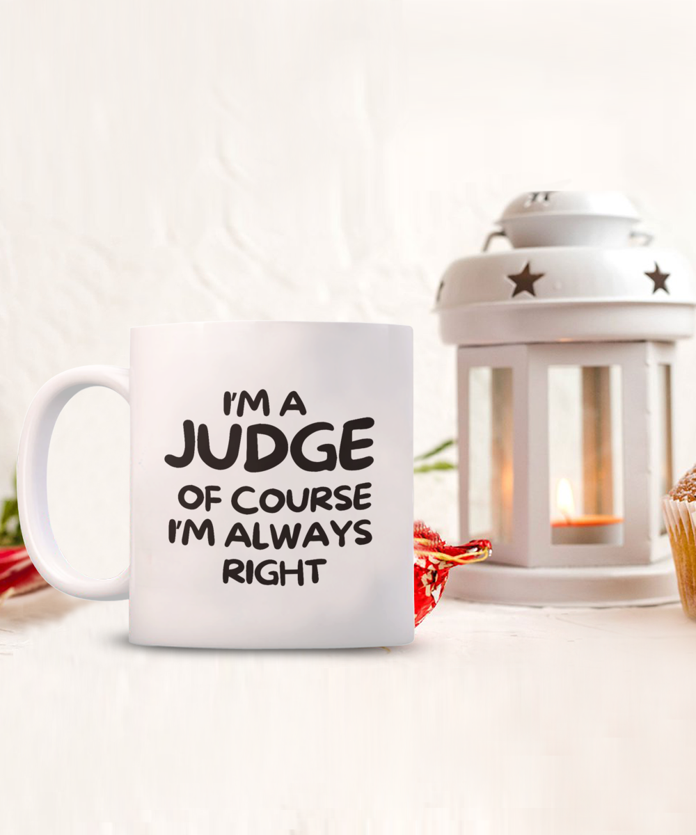 Next to a lit lantern and cupcake is the "I'm A Judge Of Course I'm Always Right" white coffee mug. Available for a limited time, it's printed and shipped from the USA with guaranteed safe checkout.