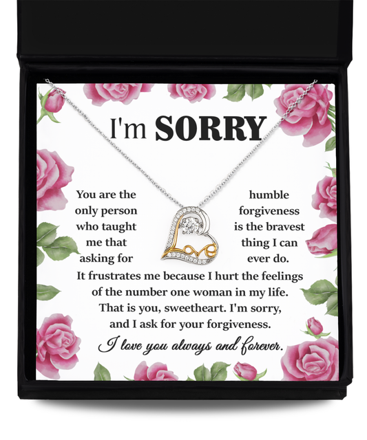 Sorry-Your Forgiveness - Love Dancing Necklace, a heart-shaped pendant crafted in 14k gold, displayed above an apology note featuring a floral border. The note conveys regret and a heartfelt request for forgiveness.