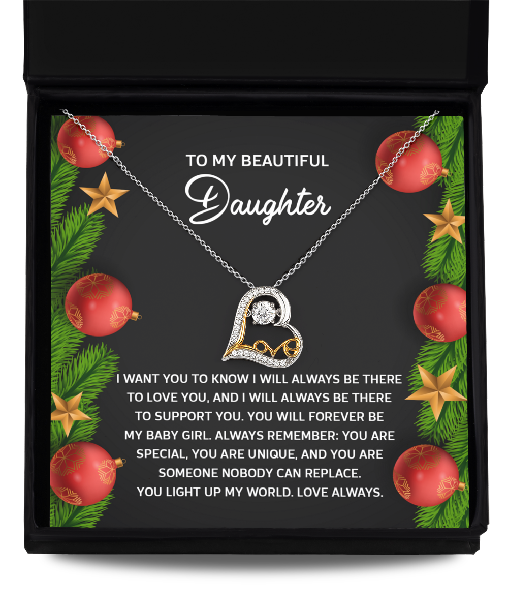 The Daughter-Nobody Can Replace - Love Dancing Necklace, beautifully crafted in 14k Gold with a heart-shaped design and a crystal centerpiece, is elegantly presented in a gift box. The background features red ornaments and green foliage, accompanied by the message: "To my beautiful daughter" and a heartfelt note.