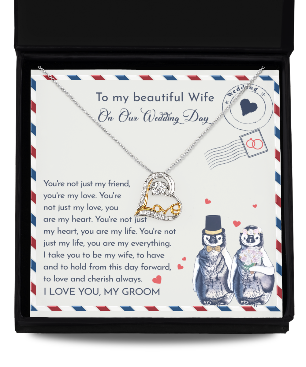 A To Wife Wedding, Love And Cherish - Love Dancing Necklace with a heart-shaped pendant in .925 Sterling Silver, presented in a box featuring a heartfelt message to a wife on their wedding day, accompanied by an illustration of two penguins dressed as bride and groom.