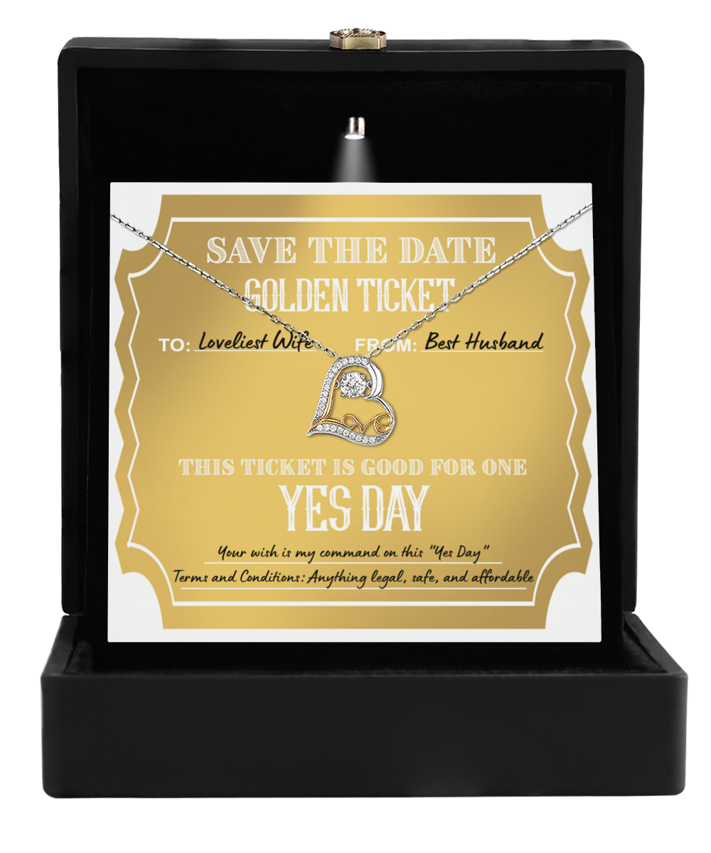 A "To Wife-Golden Ticket" nestled in a black box with a Love Dancing Necklace, showcasing a heart-shaped 14k gold pendant.