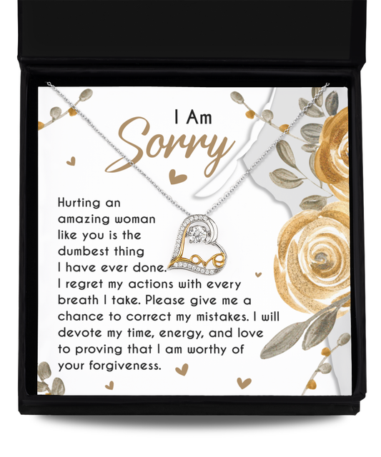 The Sorry-Amazing Woman - Love Dancing Necklace, a handcrafted Sterling Silver piece featuring a heart pendant, is elegantly displayed on a card that reads: "I Am Sorry. Hurting an amazing woman like you is the dumbest thing I have ever done..." with a beautiful floral design framing the heartfelt message.