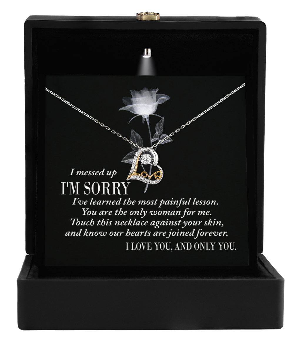 The Sorry-Painful Lesson - Love Dancing Necklace in a black box includes a heartfelt message of apology and love.