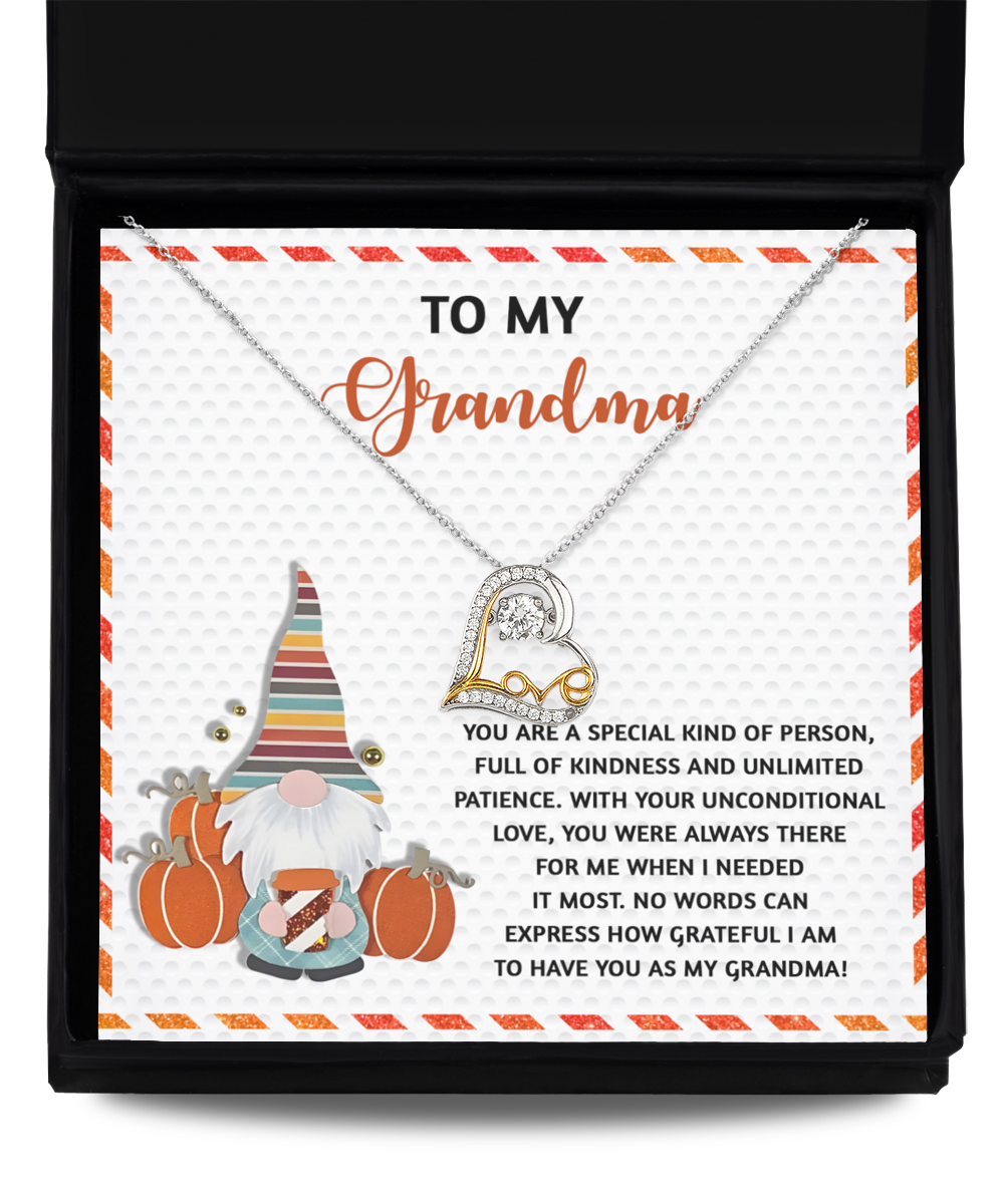 Introducing the Grandma-Needed It Most - Love Dancing Necklace, elegantly presented in a gift box. This beautiful necklace features a heart pendant crafted in stunning 14k Gold, accompanied by the message "To My Grandma" and a touching note paired with an illustration of a gnome surrounded by pumpkins.