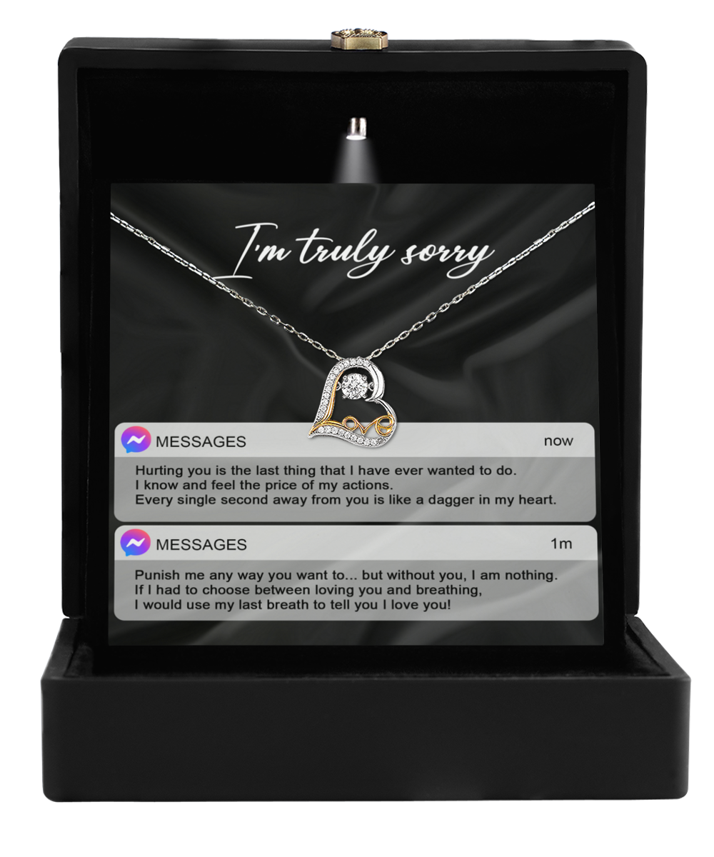 The Sorry-Away From You - Love Dancing Necklace, featuring a heart-shaped pendant crafted from 14k gold, is presented in a black box with a heartfelt message saying, "I'm truly sorry," along with two sincere apology text messages.