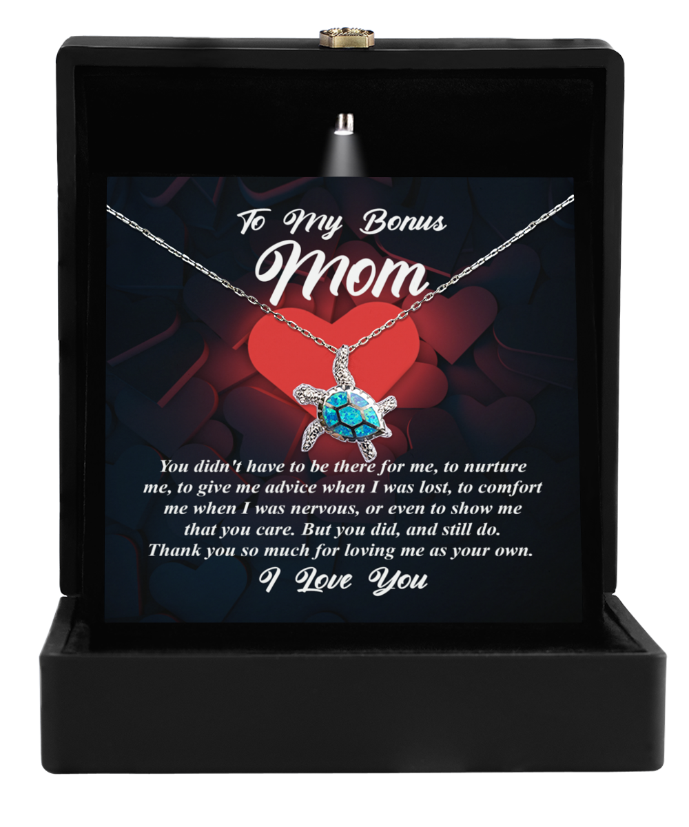 A To Bonus Mom, That You Care - Opal Turtle Necklace by Gearbubble displayed in a box with a sentimental message addressed to a 'bonus mom,' symbolizing love.
