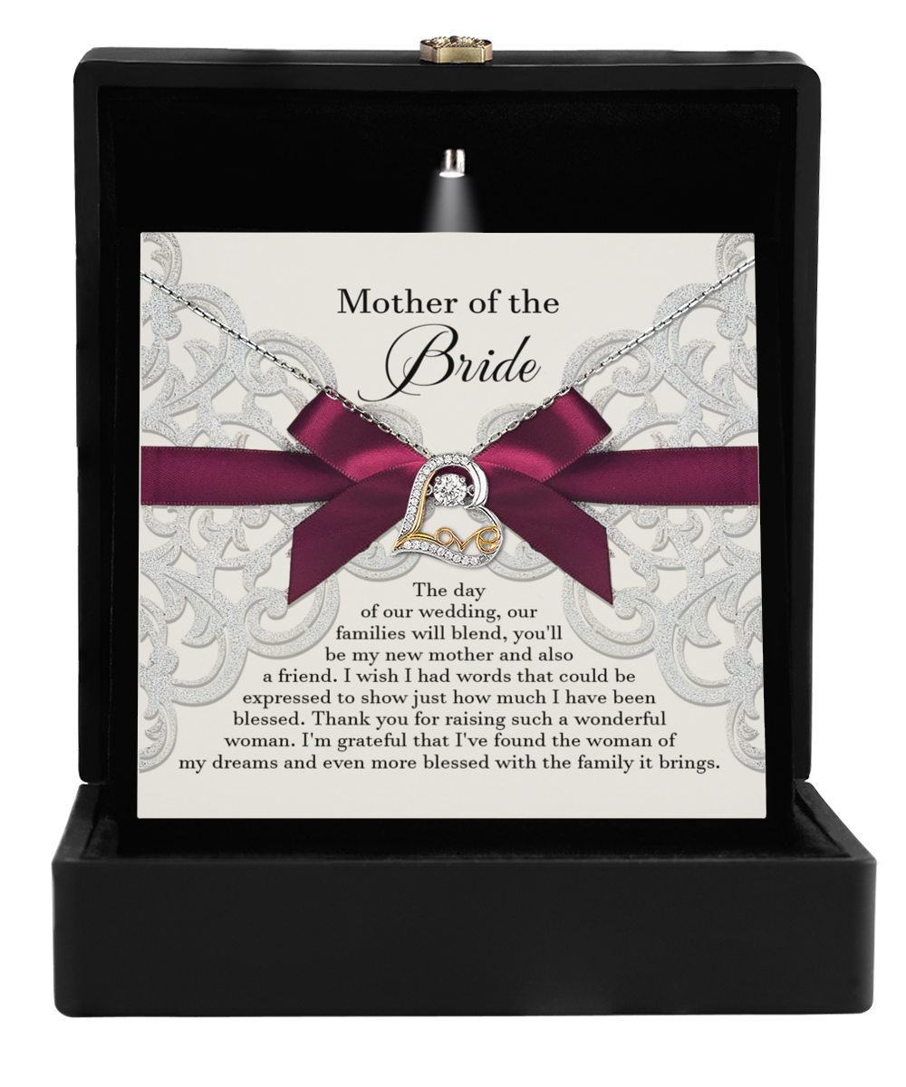 A decorative box featuring a card titled "To Bride's Mom, My New Mother" includes an emotional message along with the exquisite Love Dancing Necklace, adorned with a heart and infinity pendant symbolizing eternal maternal love.