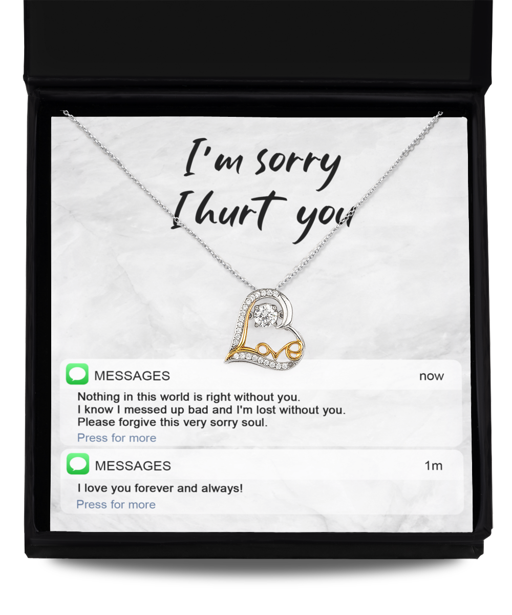 The Sorry-Lost Without You - Love Dancing Necklace, a 14k gold plated necklace featuring a double heart pendant, is elegantly presented in a box with the heartfelt message, "I'm sorry I hurt you," accompanied by two text message notifications below conveying regret and love.