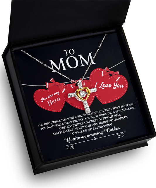 A necklace in a gift box with a heart pendant, inscribed with messages of love and appreciation for a mother, celebrating the unique bond with a "To Mom, You Did It - Cross Dancing Necklace" title.