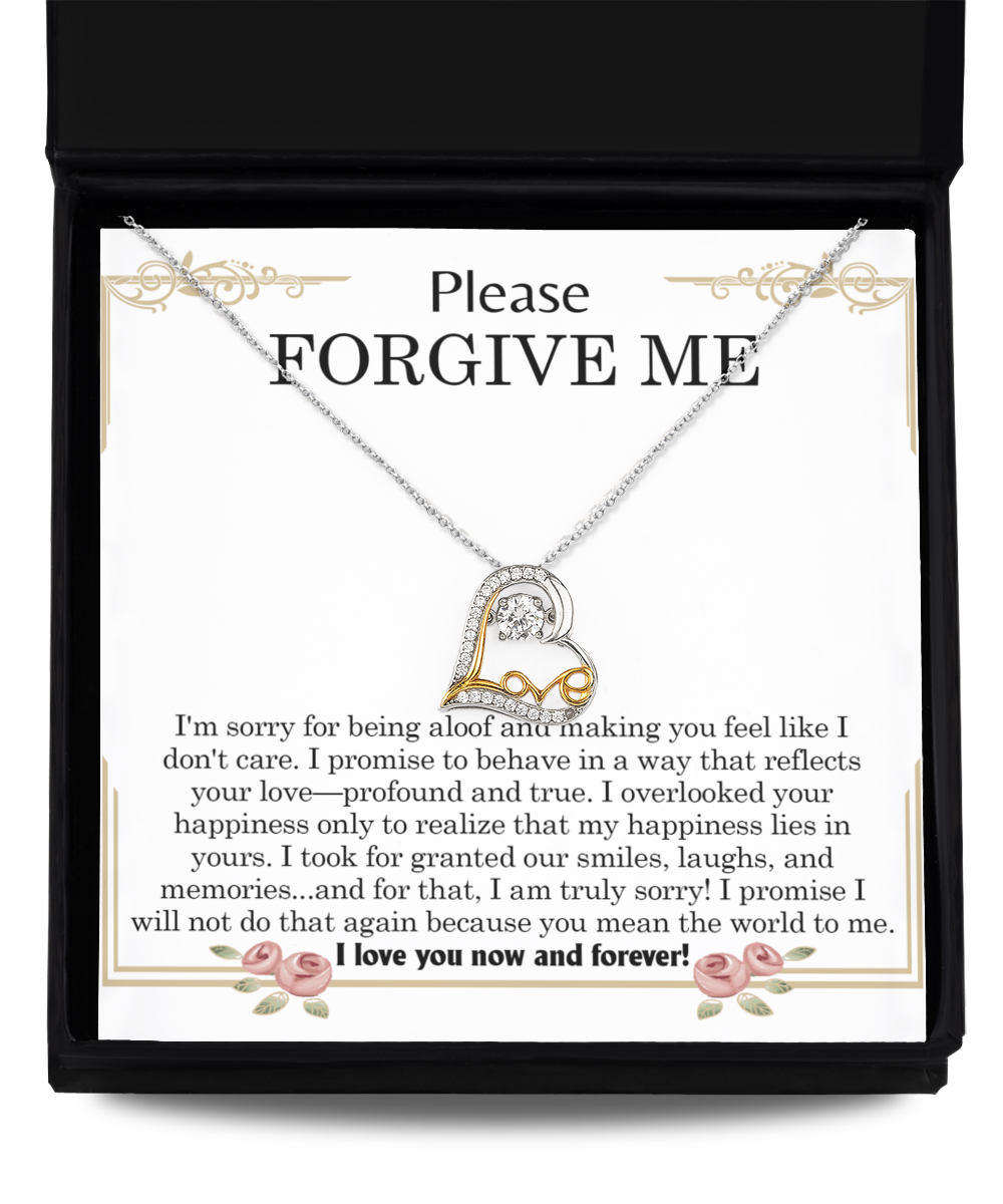 The "Sorry-Profound And True- Love Dancing Necklace," a heart-shaped pendant crafted in sterling silver, is displayed in a black box with a note that reads, "Please Forgive Me," featuring a heartfelt message of apology and love.