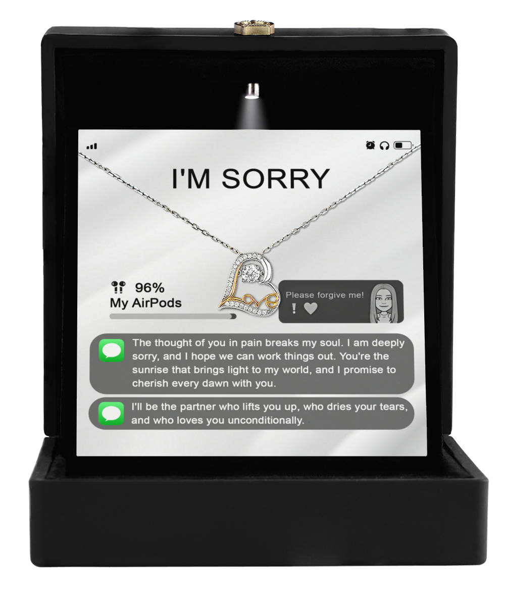 The Sorry-Breaks My Soul - Love Dancing Necklace, featuring a heart-shaped pendant in 14k gold, is elegantly presented in a black box alongside a display that shows an apology message and text messages for reconciliation.