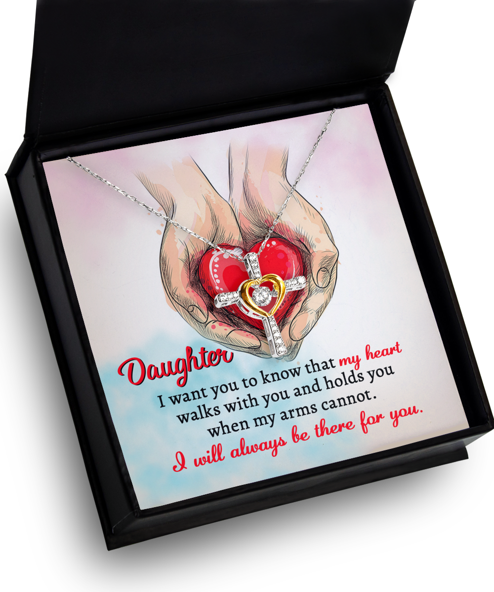 A Daughter-Always Be There - Cross Dancing Necklace inside a box with an illustration of hands holding a heart. Text reads: "Daughter, I want you to know that my heart walks with you and holds you when my arms cannot. I will always be there for you.