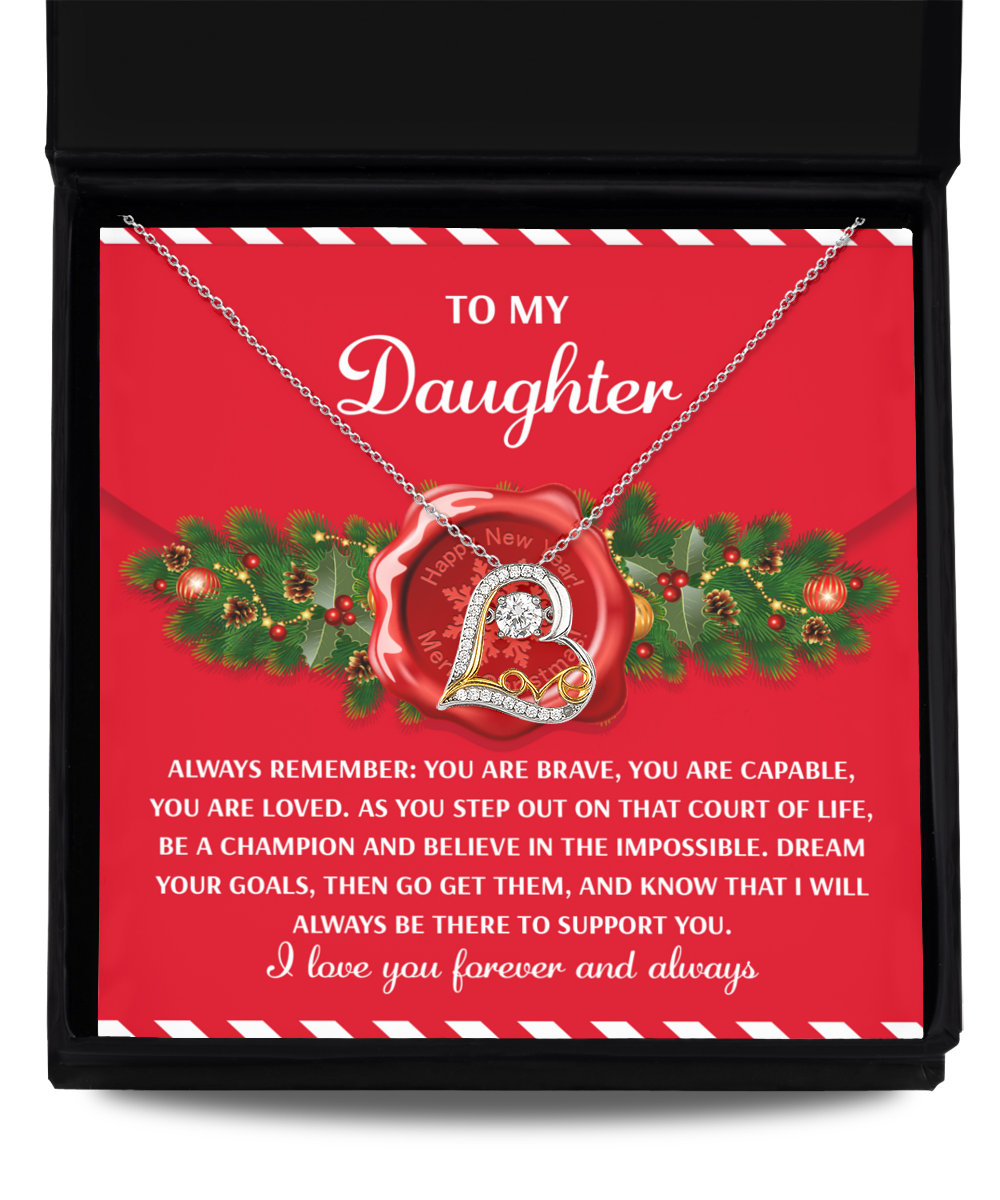 A Sterling Silver "Daughter-Be A Champion - Love Dancing Necklace" presented on a card with an inspirational message for your daughter, featuring festive Christmas decorations.