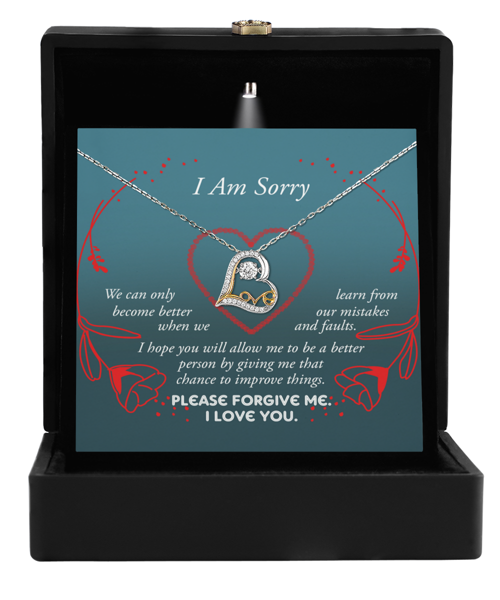 A Sorry-Mistakes And Faults - Love Dancing Necklace in a black jewelry box with an apology message printed inside.