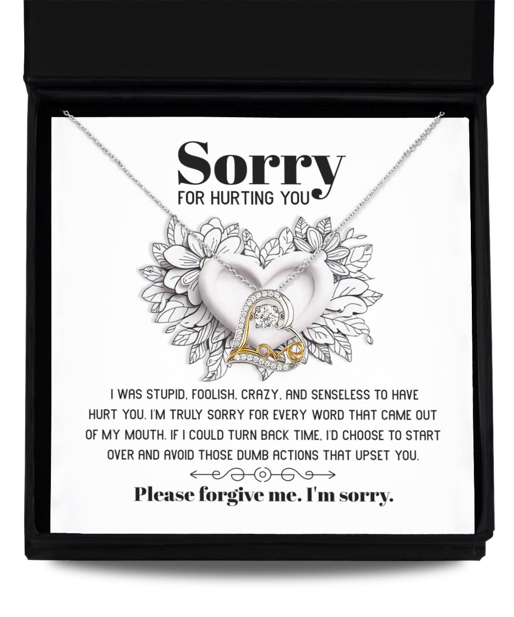 A stunning heart-shaped necklace, the Sorry-Turn Back Time - Love Dancing Necklace, featuring 14k gold plating and accompanied by a heartfelt note expressing an apology for past actions and a plea for forgiveness.