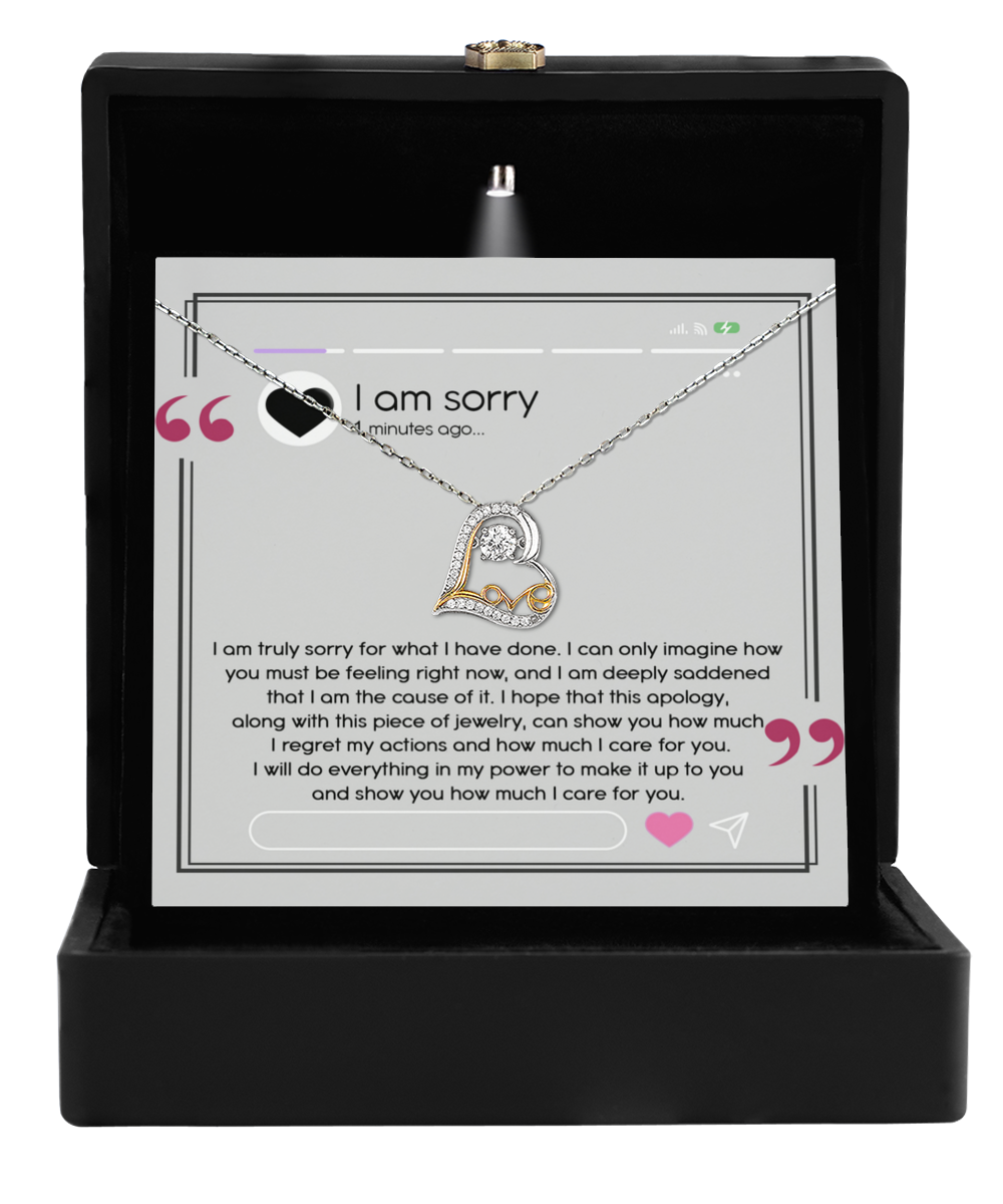 A sterling silver heart-shaped necklace, named the Sorry-Care For You - Love Dancing Necklace, is elegantly showcased in an open box with an apology message inscribed inside. The message conveys profound regret, love, and a promise to make things right.