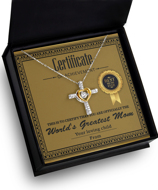 A Cross Dancing necklace with a heart-shaped pendant displayed in a box, accompanied by a "World's Greatest Mom" certificate and a "best mom" badge.