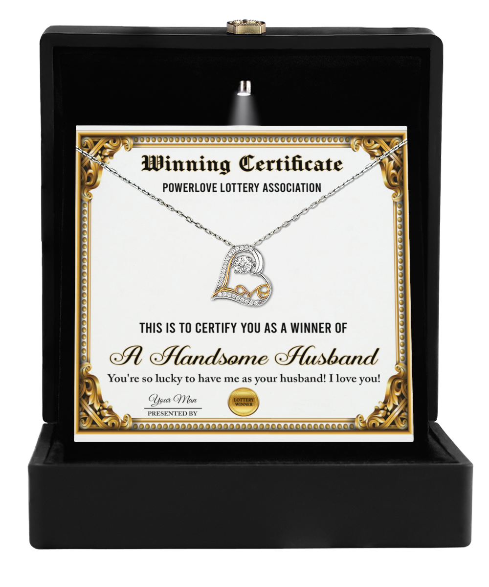 A "To Wife-Winning Certificate" in a sleek black box features a stunning Love Dancing Necklace, complete with a 14k gold heart-shaped pendant, presented by the Powerlove Lottery Association to declare you as "A Handsome Husband." It's an ideal gift to show appreciation for your wife.