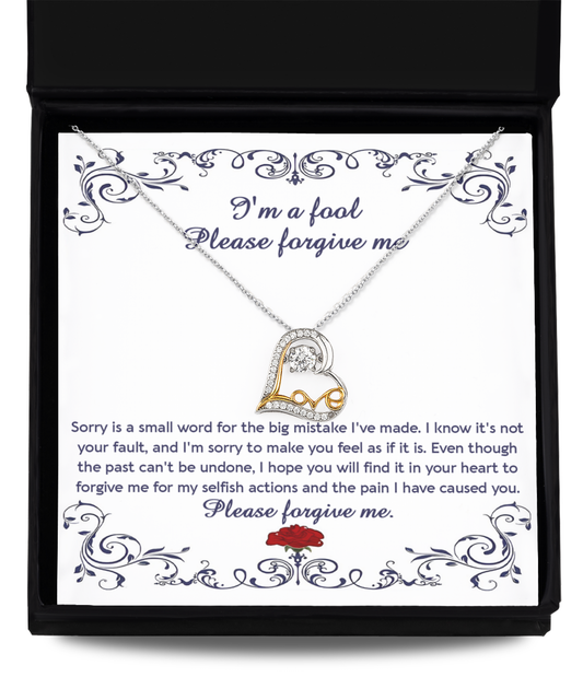 The "Sorry-I'm A Fool - Love Dancing Necklace" features a sterling silver chain with a heart-shaped pendant, elegantly presented in a box that includes an apology letter reading, "I'm a fool. Please forgive me," accompanied by an apologetic message and a rose illustration.