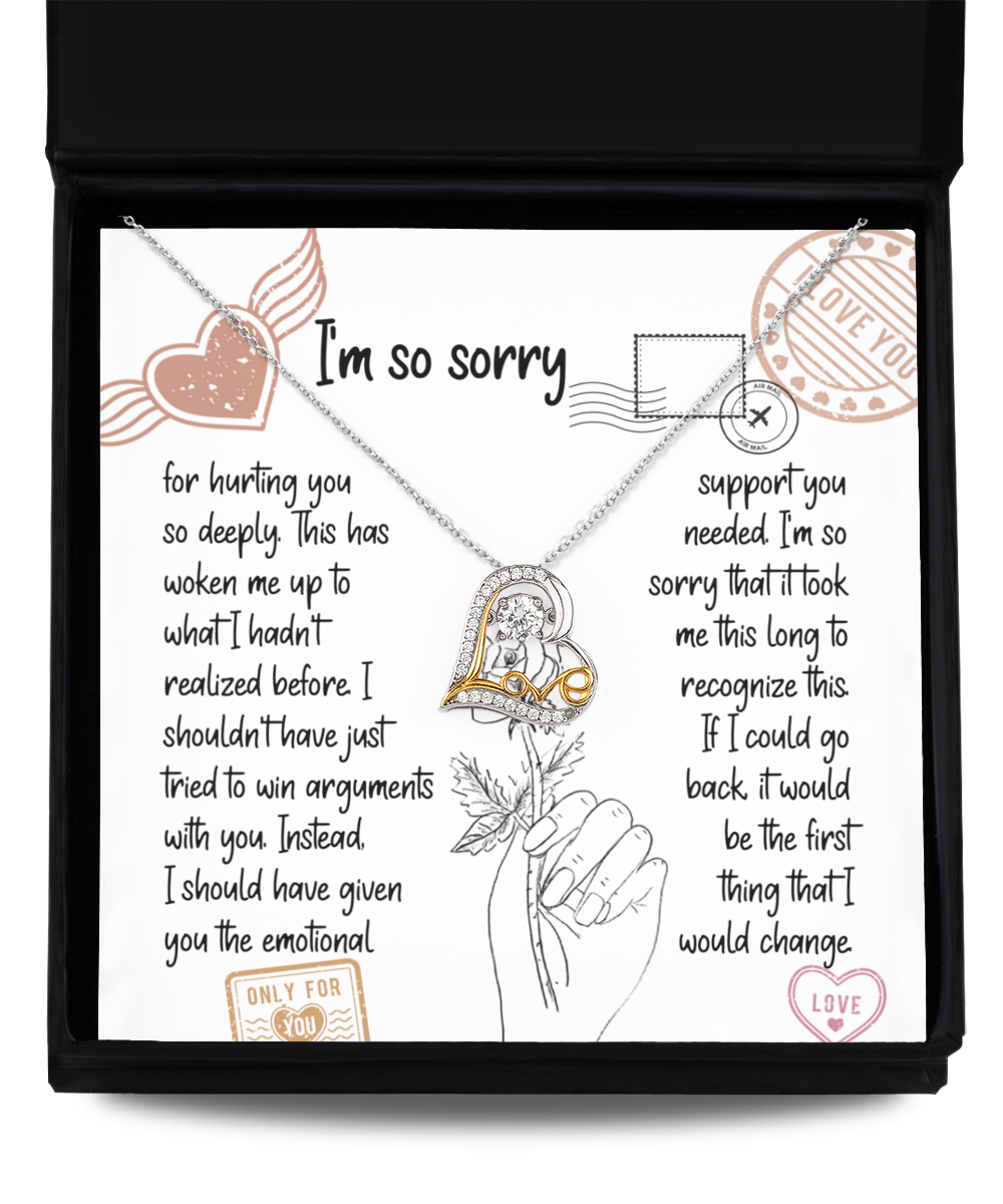 A "Sorry-Emotional Support- Love Dancing Necklace" with a heart pendant in .925 Sterling Silver is placed on an apology card inside a box. The card contains a heartfelt apology note with various decorative stamps and illustrations.