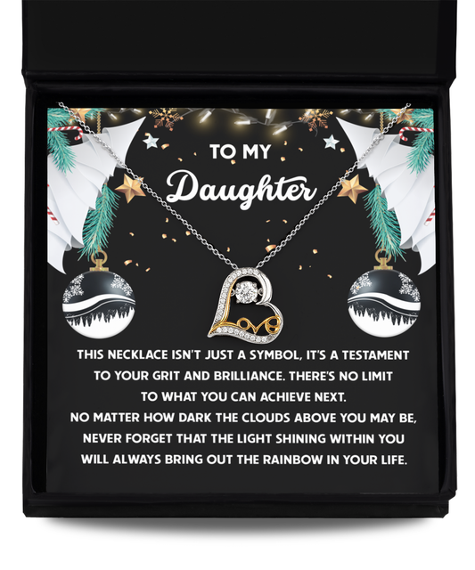 A Daughter-The Rainbow - Love Dancing Necklace in 14k gold is elegantly nestled in a gift box with a heartfelt message for a daughter, surrounded by decorative stars and ornaments.