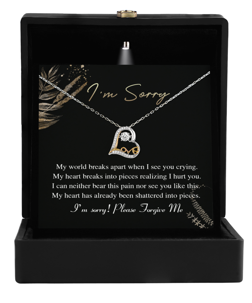 The Sorry-See You Crying - Love Dancing Necklace, featuring a 14k gold heart pendant, is elegantly presented in a sleek black box with an apology message for seeking forgiveness—perfect for your wife.