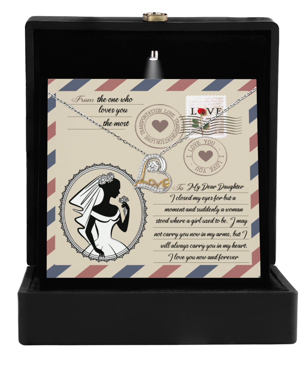 The Daughter Wedding-In My Arms - Love Dancing Necklace is elegantly displayed in a black box, accompanied by a card showcasing the silhouette of a woman alongside text and postage stamp designs. It's the perfect gift to celebrate maternal love.