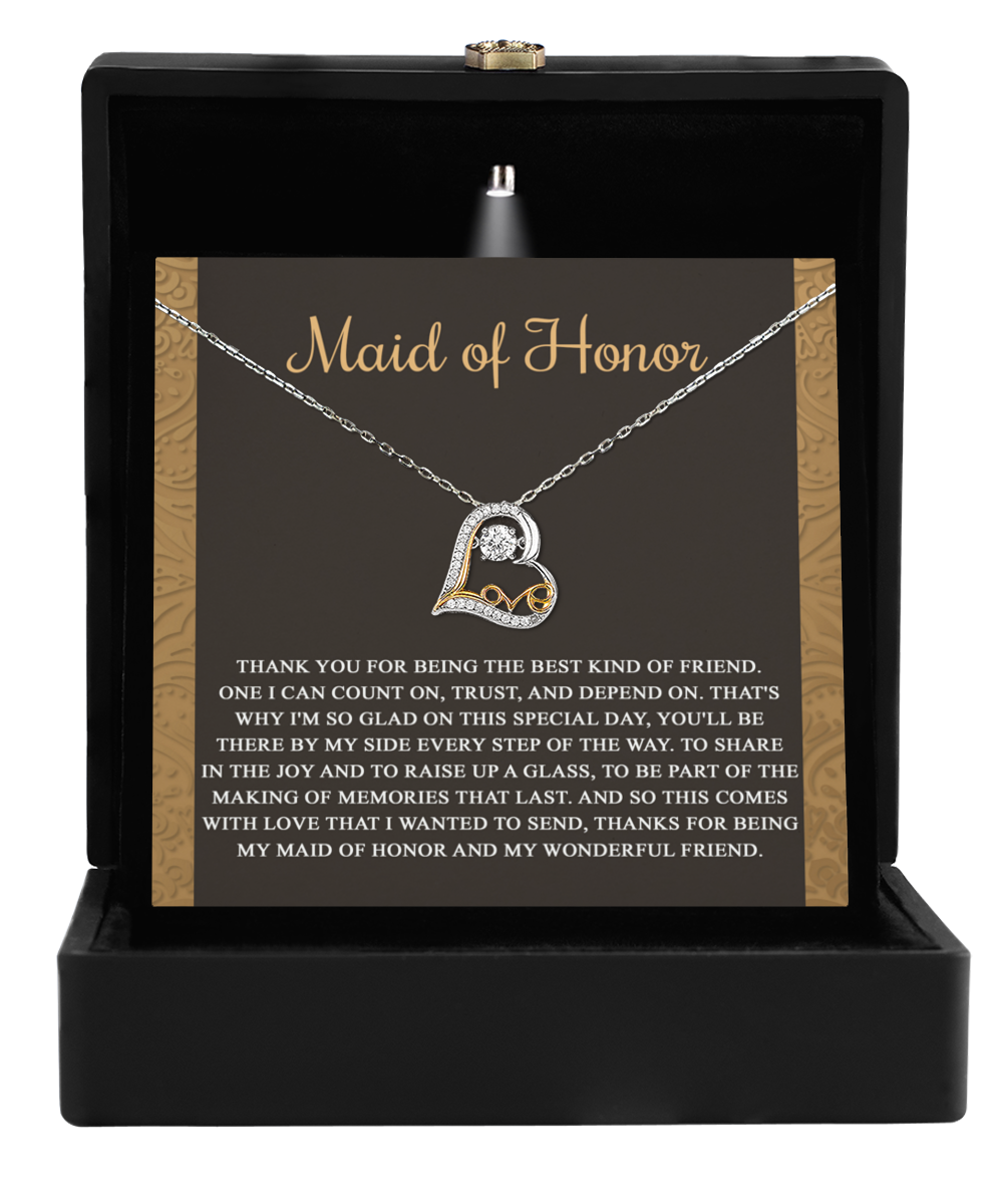 The To Maid of Honor-Kind Of Friend - Love Dancing Necklace, crafted from 14k gold in a heart shape, is elegantly packaged in a box with a card reading "Maid of Honor," expressing gratitude and appreciation for friendship and support.