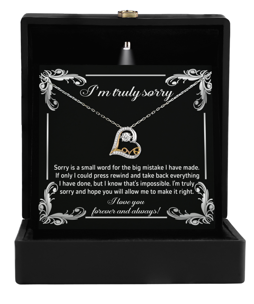 The Sorry-Make It Right - Love Dancing Necklace, featuring a heart-shaped pendant with crystals in a sleek black gift box, expresses "I'm truly sorry" with an apology note below. It's as precious as 14k gold.