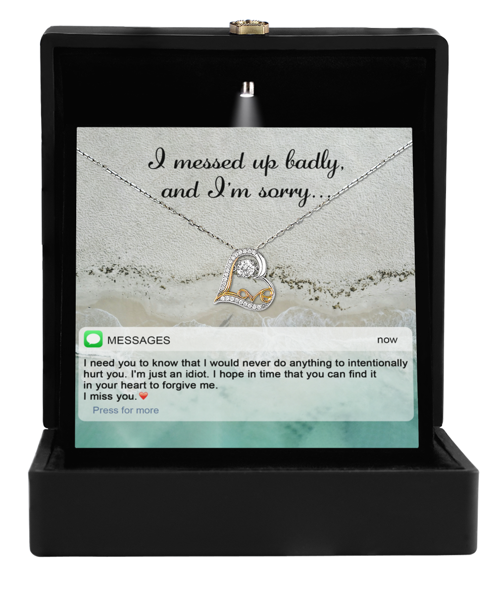 The Sorry-Just An Idiot - Love Dancing Necklace, featuring a heart-shaped pendant, is elegantly displayed in a box with a card softly whispering, "I messed up badly, and I'm sorry..." Beneath it lies an apology expressing deep regret and the hope for forgiveness.