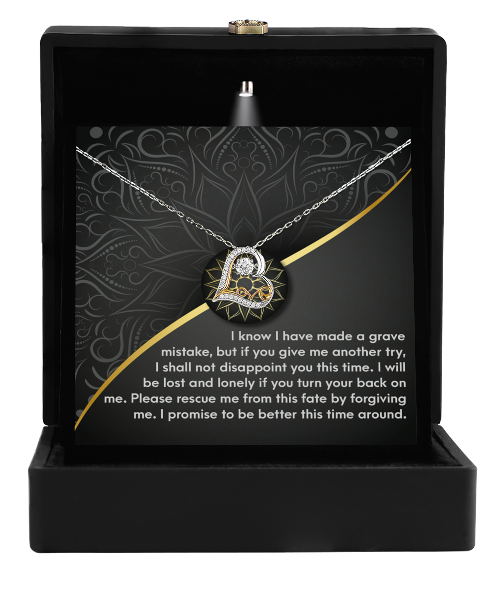 A Sorry-Turn Your Back - Love Dancing Necklace in an open black box. The box has a message card that features an engraved apology and appeal for forgiveness. This .925 Sterling Silver necklace truly symbolizes a heartfelt gesture of reconciliation.