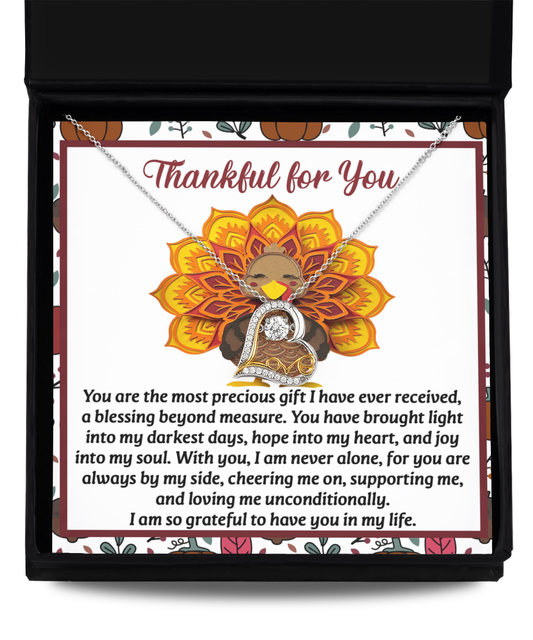 In a box, the Thanksgiving-Into My Heart - Love Dancing Necklace is elegantly displayed alongside a heartfelt message card featuring a decorated turkey and a note of gratitude and love.