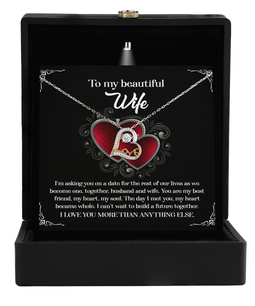 The "To Wife, Heart Became Whole - Love Dancing Necklace" comes in a black box and features a heart-shaped pendant with an elegant letter "L" design. It includes a card addressed to "My beautiful Wife" that carries a romantic message, making it the perfect gift for your wife that beautifully expresses love and devotion.