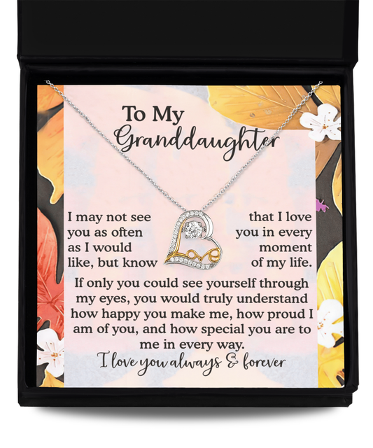 The Granddaughter-In Every Way - Love Dancing Necklace, crafted from sterling silver and featuring a heart pendant, is elegantly presented on a card adorned with floral designs and carries a heartfelt message to a granddaughter.