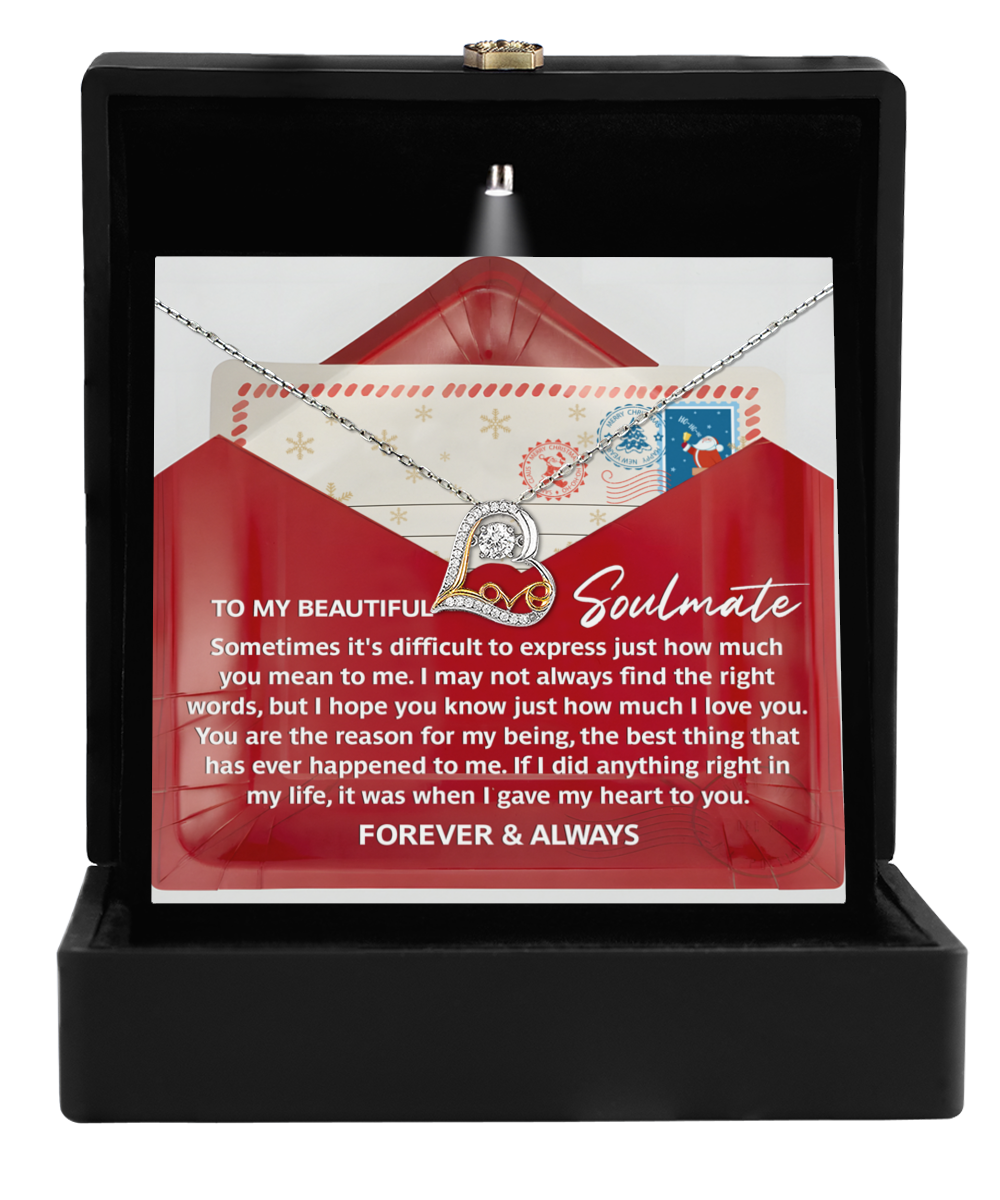 The Soulmate-Right Words - Love Dancing Necklace, crafted in 14k gold, rests in a black box with a heartfelt letter addressed to a "beautiful soulmate.