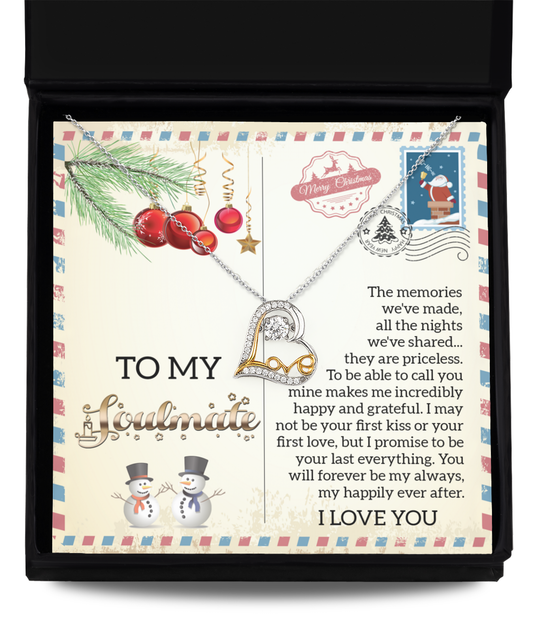 The Soulmate-Last Everything - Love Dancing Necklace, featuring a heart pendant elegantly rhodium plated, comes in a black box. The background includes a festive design with ornaments, snowmen, and a heartfelt letter expressing love.