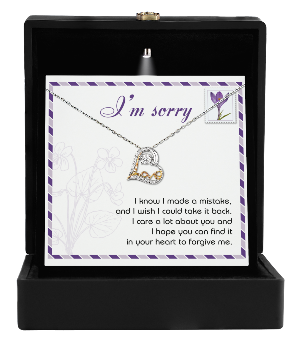 The Sorry-Take It Back - Love Dancing Necklace, crafted in 14k gold with a heart-shaped pendant, elegantly arrives in a black jewelry box and includes a heartfelt card reading "I'm sorry" to convey your sincere apology.