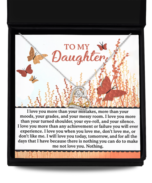 Gift your daughter a heartwarming necklace, the "Daughter-Love You More" Love Dancing Necklace, crafted in sterling silver. It comes beautifully packaged in a gift box featuring heartfelt messaging and a background adorned with butterflies and flowers.