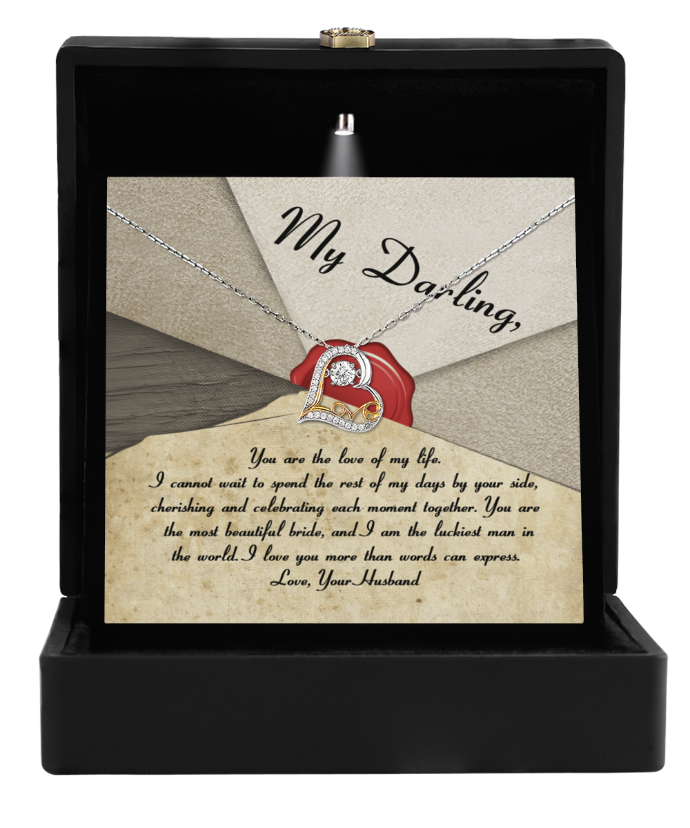 The Bride-Each Moment Together - Love Dancing Necklace, crafted in 14k gold and featuring a heart pendant, is beautifully presented in a box. A heartfelt card accompanies the necklace, with a touching message from a husband to his wife, expressing love and appreciation—making it an ideal gift for their special day.