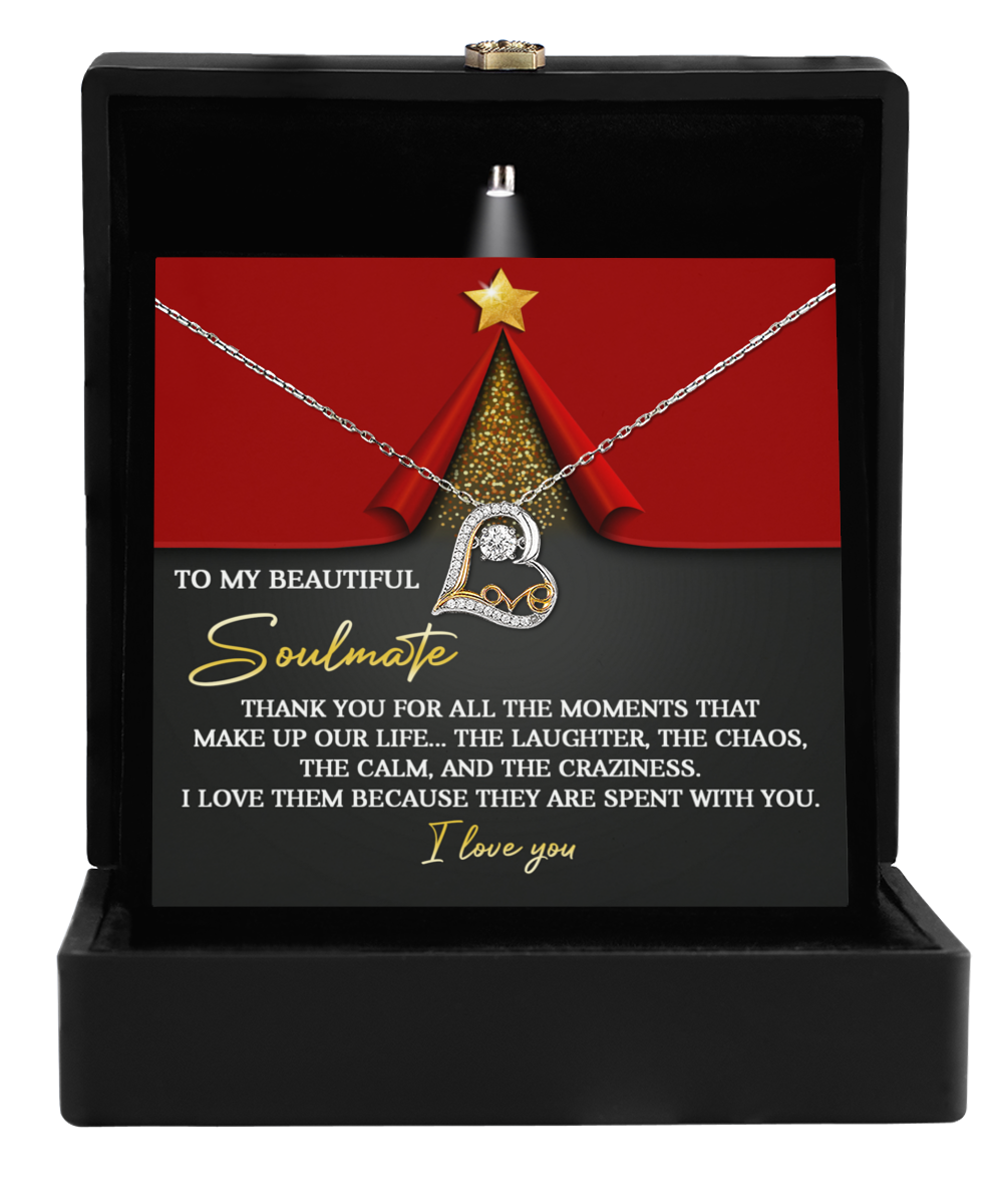 The Soulmate-The Moments - Love Dancing Necklace is elegantly displayed in a black box, accompanied by a heartfelt message to a soulmate on a decorative card.