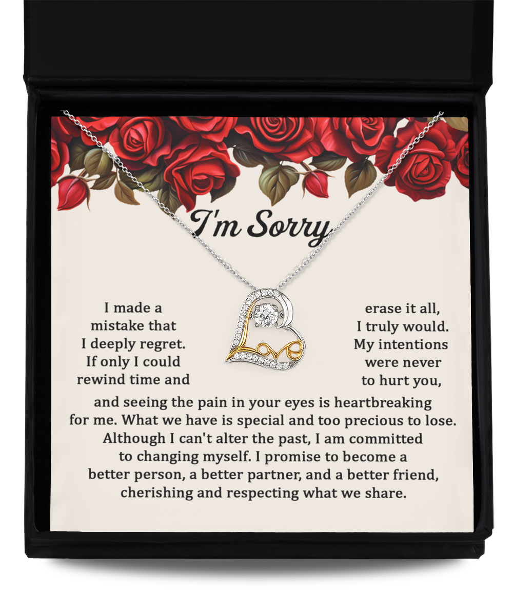 The Sorry-Precious To Lose - Love Dancing Necklace, a 14k gold plated piece with a heart-shaped pendant, is showcased on a note that bears an apology message and is adorned with red roses.