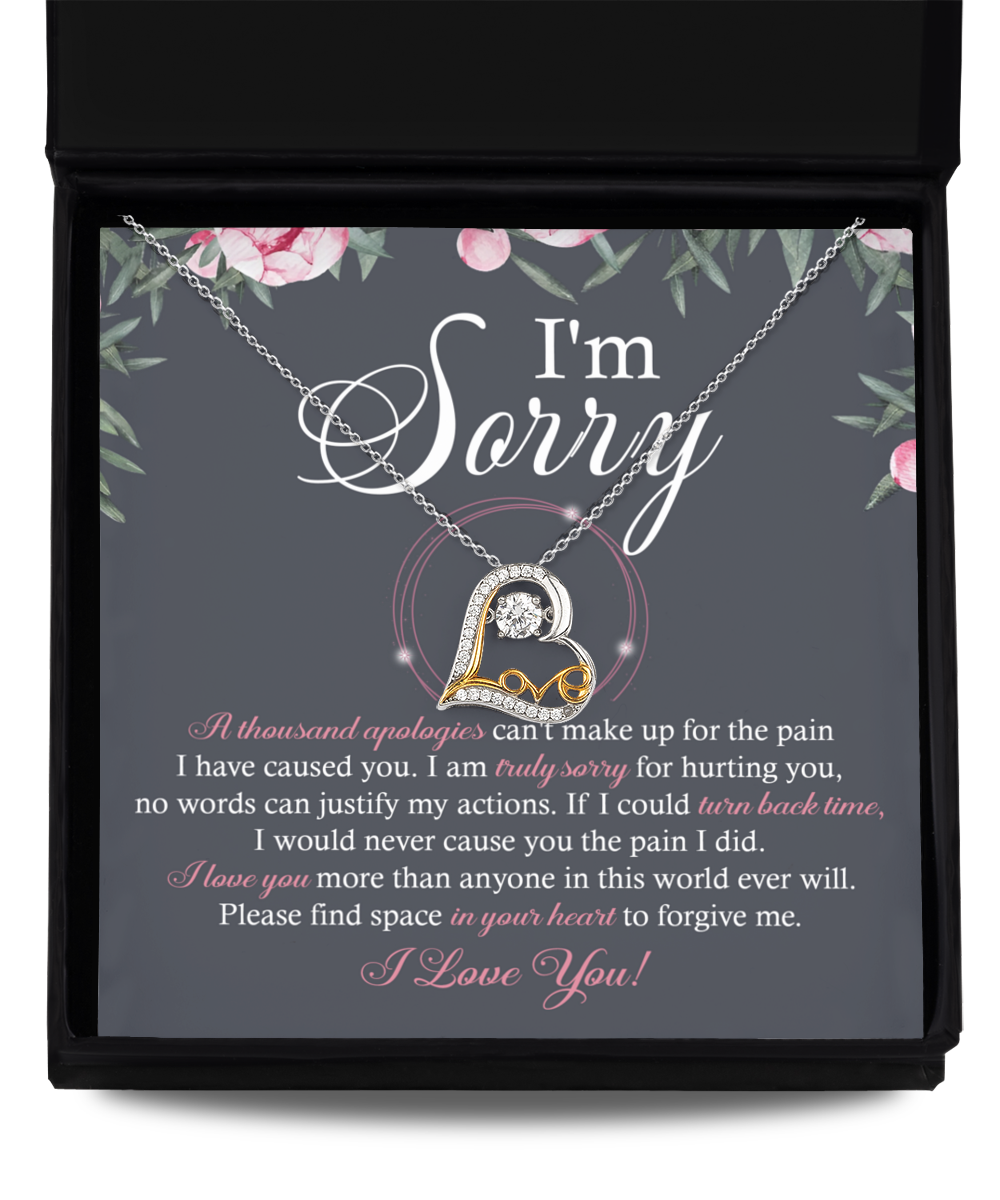 A Sorry-World Ever Will - Love Dancing Necklace, featuring a heart-shaped pendant crafted from 14k gold, rests on a card with a heartfelt apology message that reads: "I'm Sorry" and includes an extensive text expressing regret and seeking forgiveness.