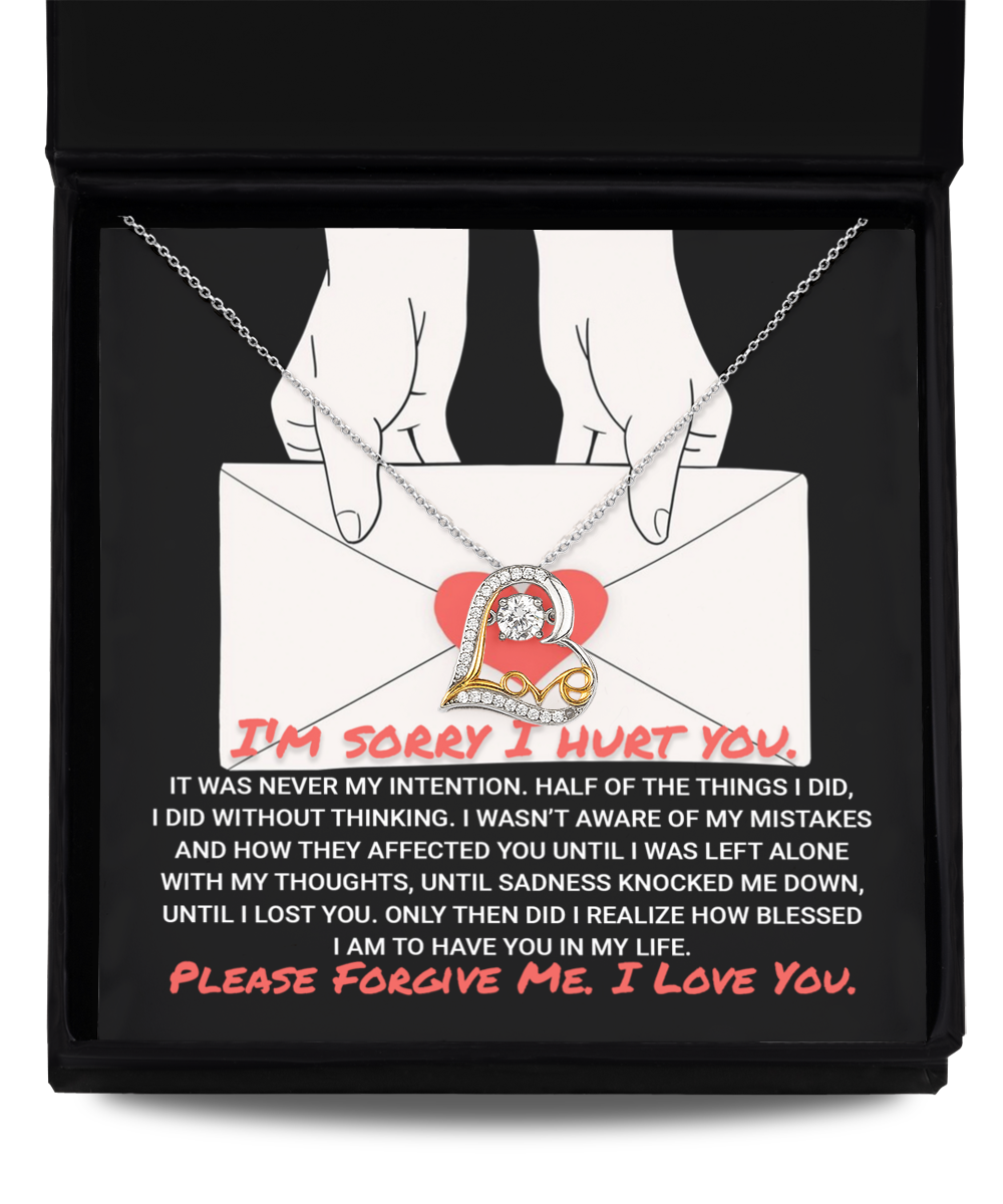 A "Sorry-Without Thinking - Love Dancing Necklace" box with an envelope and an 'I'm Sorry I Hurt You' note, featuring a 14k gold script heart-shaped pendant letter 'L' necklace. The note expresses a heartfelt apology and love.