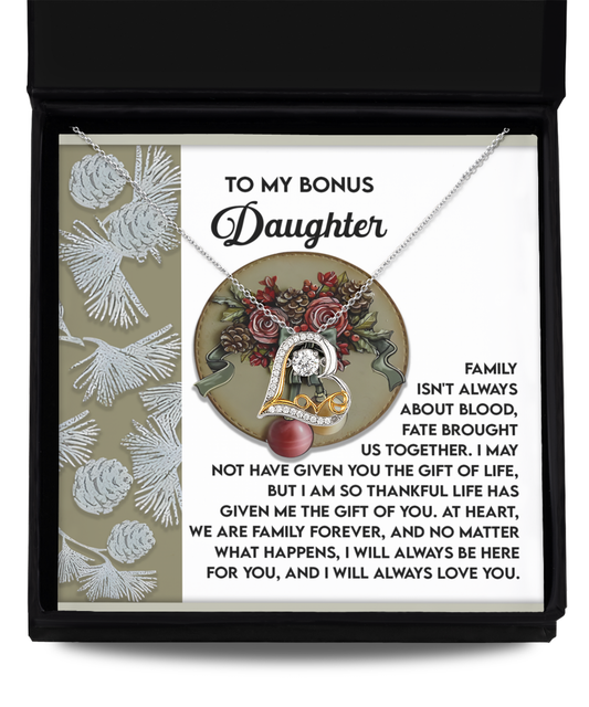 The Bonus Daughter-Gift Of You - Love Dancing Necklace features a floral pendant elegantly crafted from 14k gold and comes beautifully presented in a box. It includes an engraved message, "To my bonus daughter..." along with a heartfelt note about family and everlasting love.