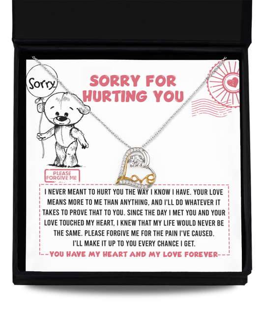 The "Sorry-Every Chance - Love Dancing Necklace," a 14k gold-plated necklace with a heart pendant, is elegantly placed on a card displaying an apology message. The card features an illustration of a sad bear holding a heart and the heartfelt text, "Sorry for hurting you, please forgive me.