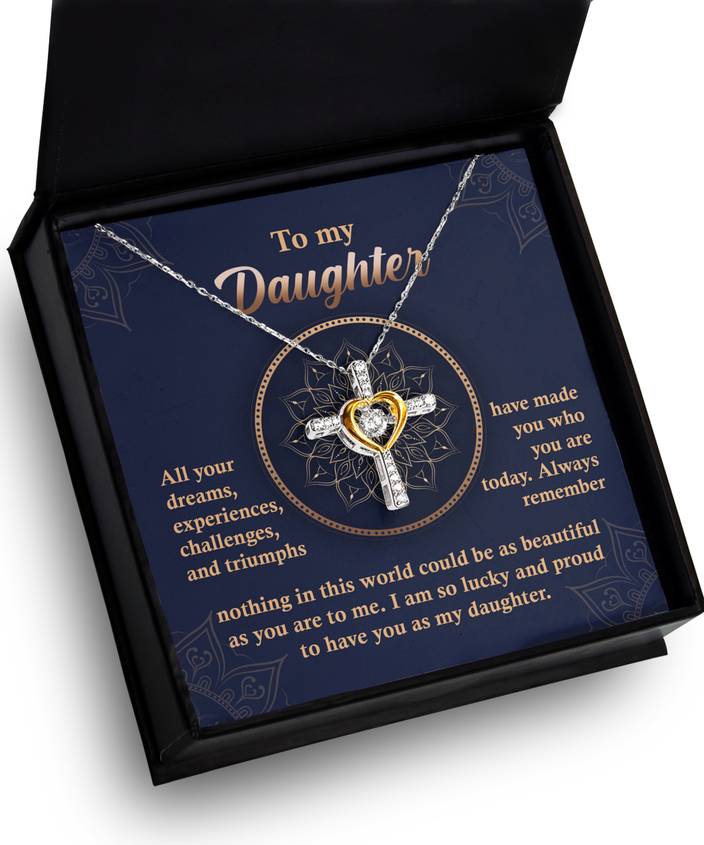 A Daughter-All Your Dreams - Cross Dancing Necklace with a heart-shaped centerpiece is displayed in an open box. The message on the box is addressed to a daughter, expressing pride and love.