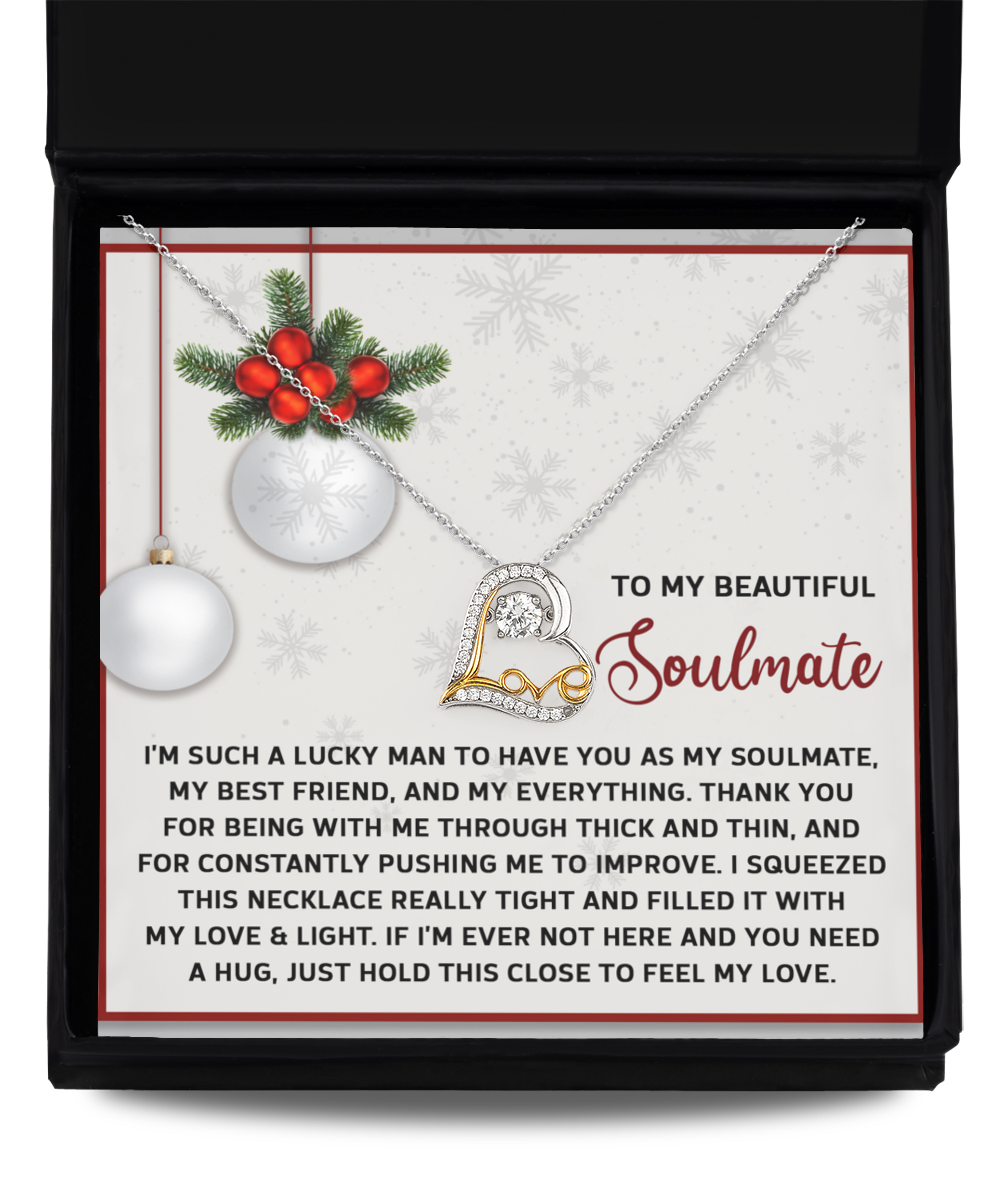 The Soulmate-Feel My Love - Love Dancing Necklace, featuring a heart pendant, is elegantly presented in an open gift box. The inside lid showcases a heartfelt message to a soulmate, embellished with festive ornaments and snowflake patterns. Available in 14k Gold or Sterling Silver, it serves as the perfect symbol of enduring love.