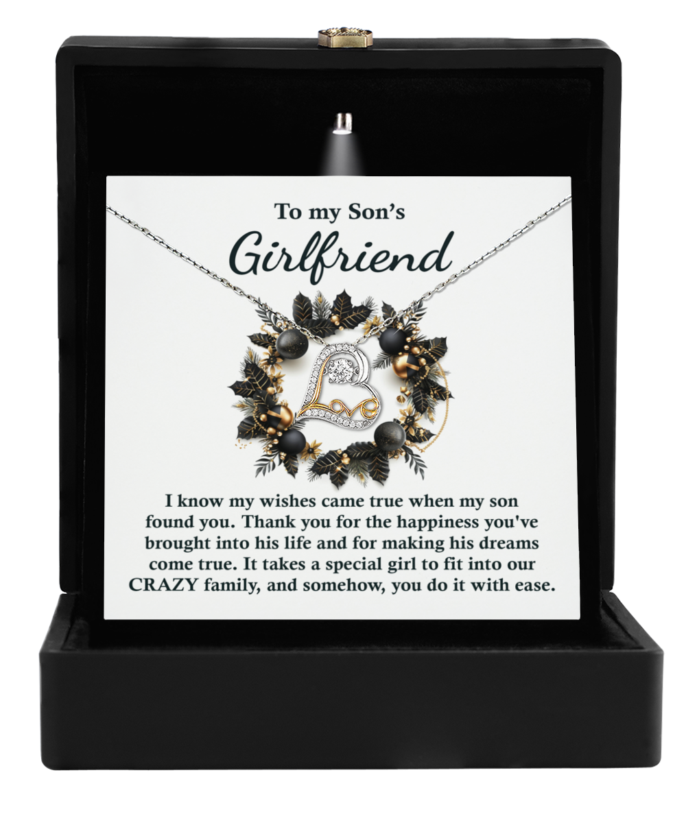 The "Son's Girlfriend - Found You - Love Dancing Necklace," crafted in stunning sterling silver, is elegantly presented in a black box. Accompanying the necklace is a card with the message: "To my Son’s Girlfriend," along with a heartfelt expression of gratitude and admiration.