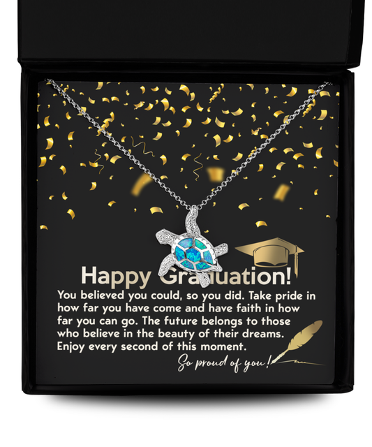 A graduation-themed Happy Graduation, This Moment - Opal Turtle Necklace in a gift box with a celebratory message and confetti.